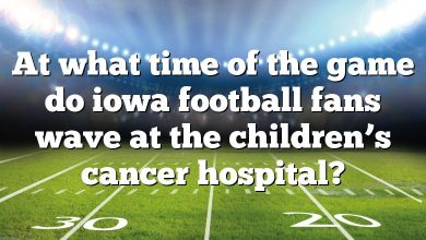 At what time of the game do iowa football fans wave at the children’s cancer hospital?