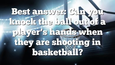 Best answer: Can you knock the ball out of a player’s hands when they are shooting in basketball?