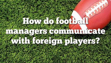 How do football managers communicate with foreign players?