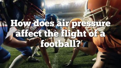 How does air pressure affect the flight of a football?
