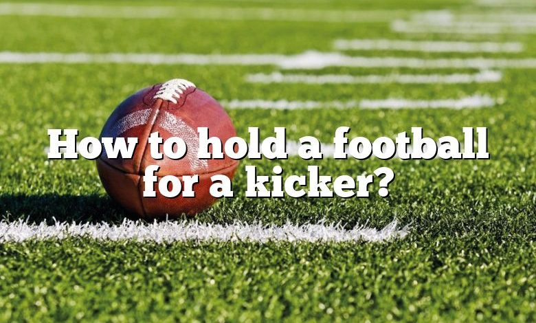 How to hold a football for a kicker?
