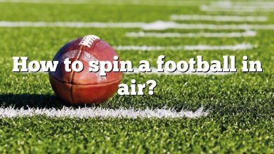 How to spin a football in air?