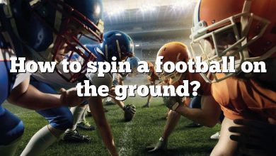 How to spin a football on the ground?