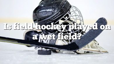 Is field hockey played on a wet field?