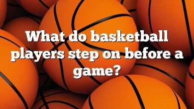 What do basketball players step on before a game?