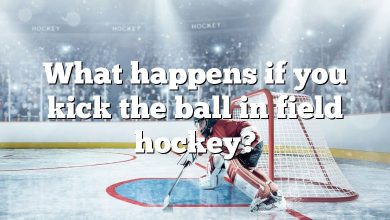 What happens if you kick the ball in field hockey?