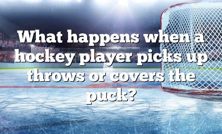 What happens when a hockey player picks up throws or covers the puck?