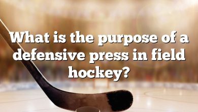 What is the purpose of a defensive press in field hockey?