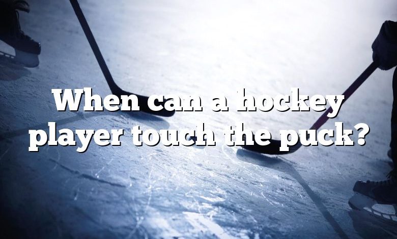 When can a hockey player touch the puck?