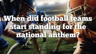 When did football teams start standing for the national anthem?