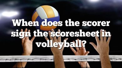 When does the scorer sign the scoresheet in volleyball?