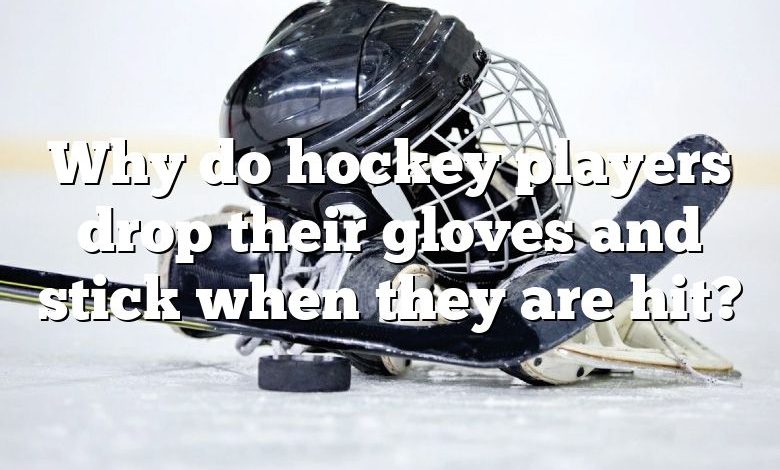 Why do hockey players drop their gloves and stick when they are hit?