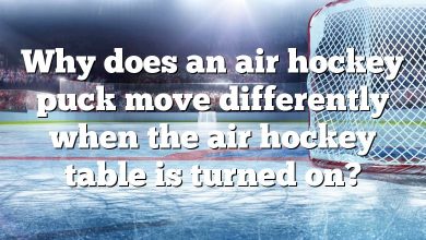 Why does an air hockey puck move differently when the air hockey table is turned on?