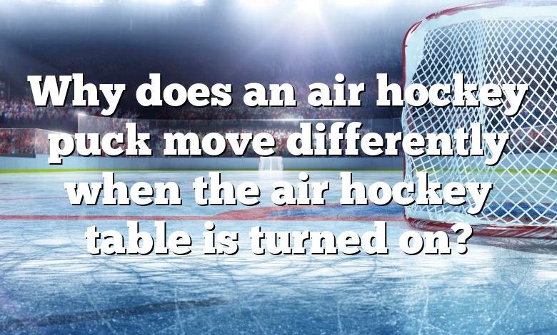 Why does an air hockey puck move differently when the air hockey table is turned on?