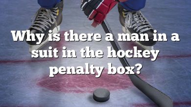 Why is there a man in a suit in the hockey penalty box?